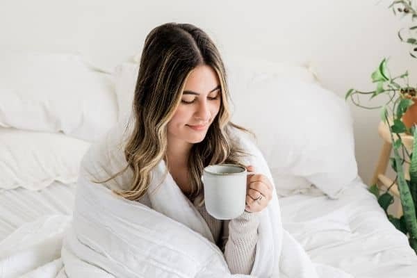 woman drinking herbal tea before sleeping