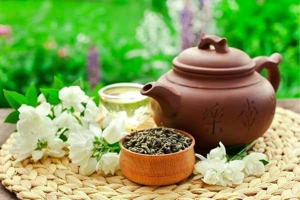 chinese clay teapot green tea and jasmine flowers