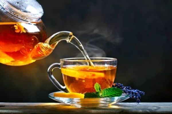 tea being poured from glass teapot