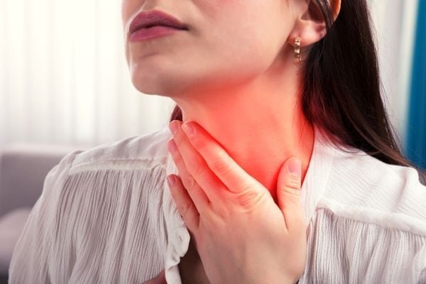 a woman with a sore throat