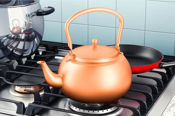 copper tea kettle on a gas stove